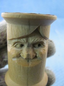 Now for a few last details around the eyes. Reduce the outside end of the lower lid to create a tiny shadow that suggests the lower lid is covered by the upper one. Use the small V-tool to cut a lower lid line curving like a reclining “S”. With a knife, round over any ridges and blend the brow with the rest of the face. While you’re rounding and shaping, work on the cheek mounds. Use the small V-tool to add a few eyebrow hairs. Don’t get carried away. A few will do.